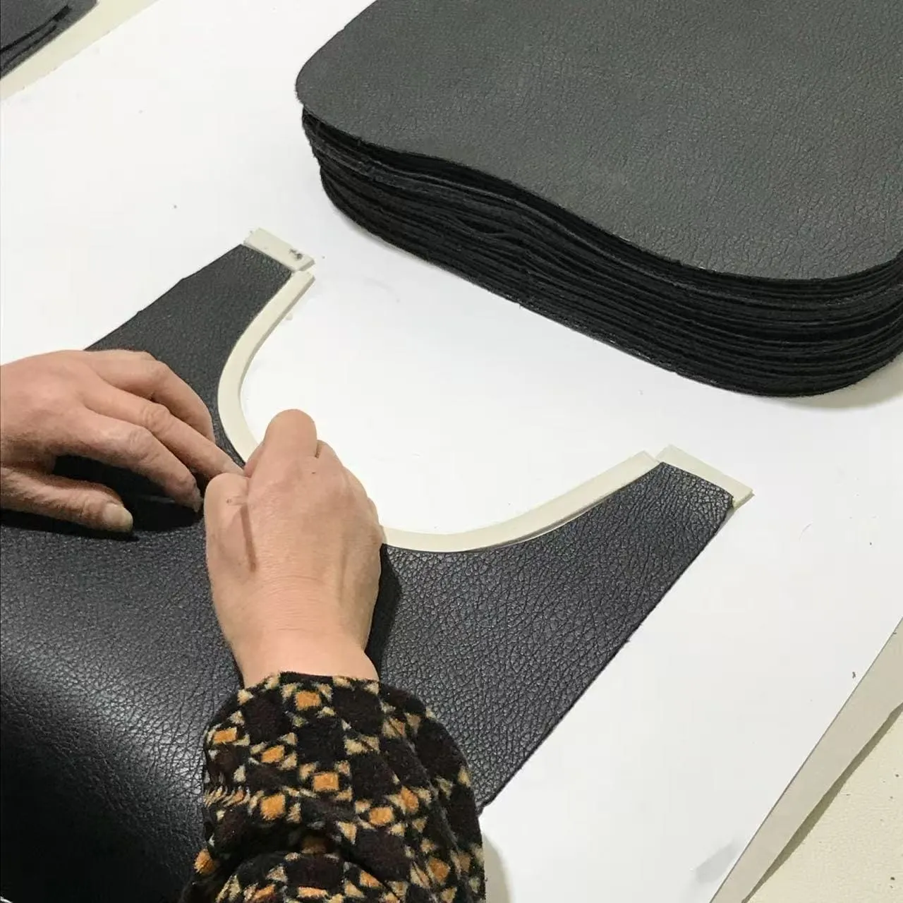 Pattern maker preparing a handbag pattern during sample development