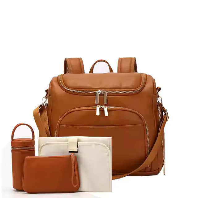 A functional and stylish custom diaper bag in rich brown leather with multiple compartments and zippers. Accompanied by matching accessories including a bottle holder, changing mat, and storage pouch, it combines practicality with modern design.