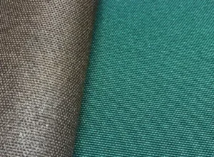 A close-up macro shot of 600D polyester canvas fabric, showing its heavy-duty woven texture. The image displays two colors: a dark grey/charcoal swatch is curled over on the left, set against a flat swatch of the same fabric in a teal-green color on the right.
